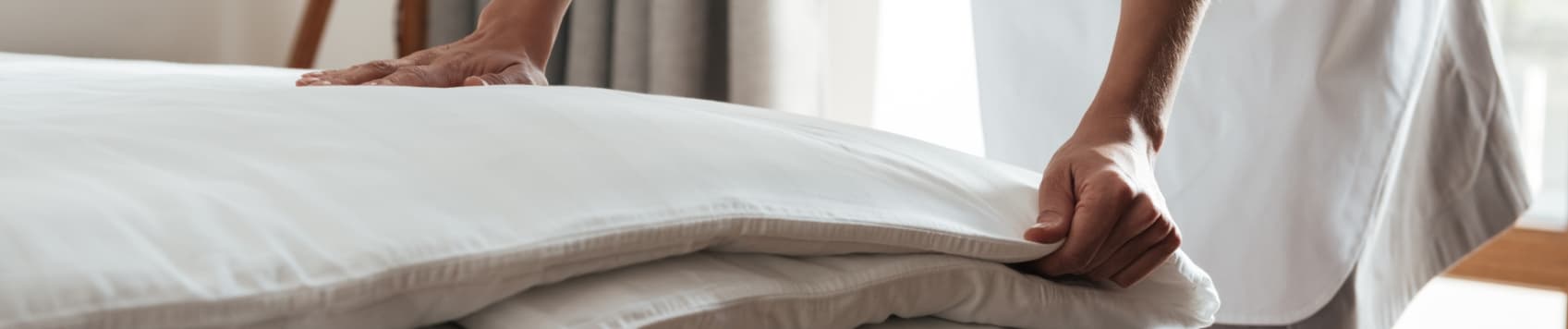 chambermaid-making-bed-in-hotel