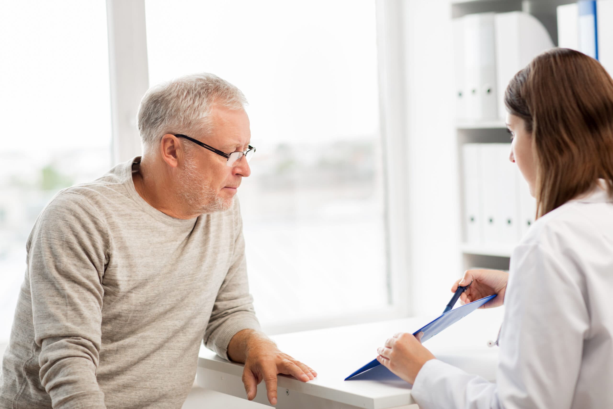 senior man and doctor meeting at hospital