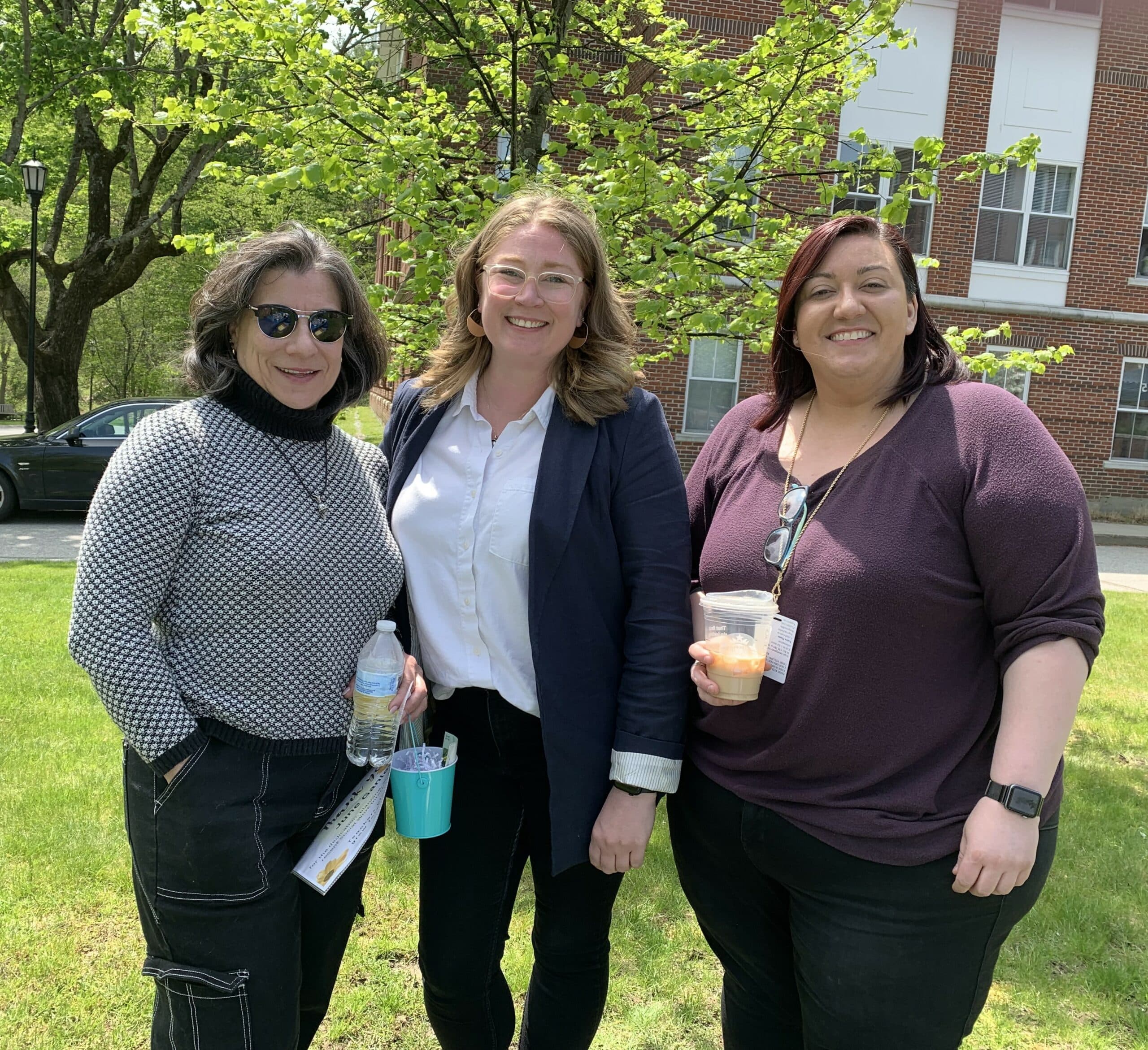Members of the adult, pediatric and perinatal palliative care team posing for a photo in front of a building.