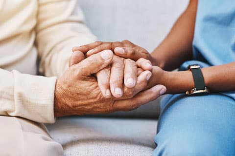 Close up of two people holding hands