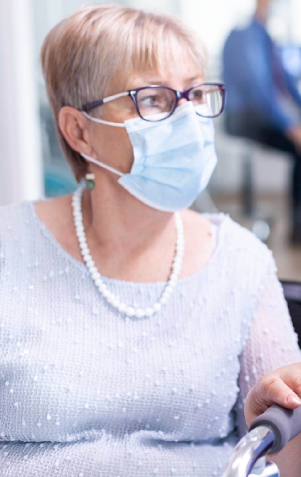 medical-staff-with-disabled-senior-woman-having-conversation-about-recovery-treatment-hospital-waiting-area-wearing-face-mask-against-coronavirus