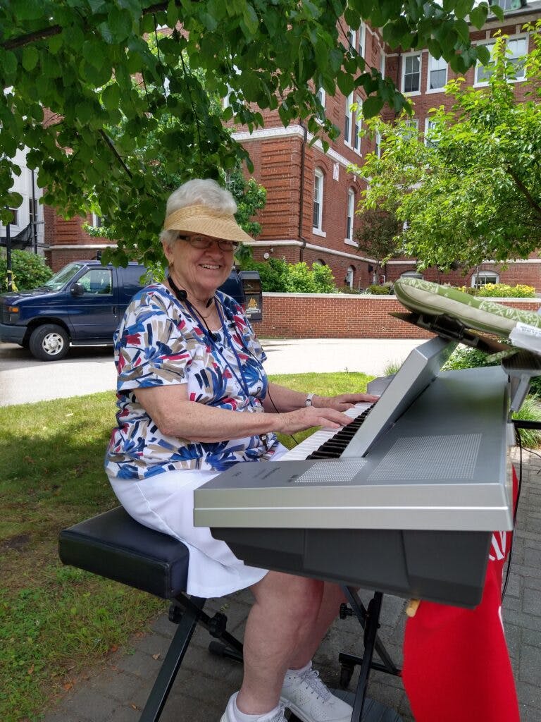 woman playing piano outside